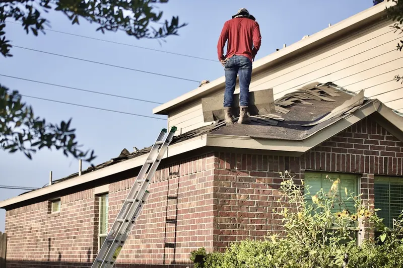 Professional roofer working on a residential roof in Ramona Park
